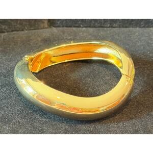 Gold-toned sculptural hinged bangle 7.25”, a chunky, organic, and wavy design